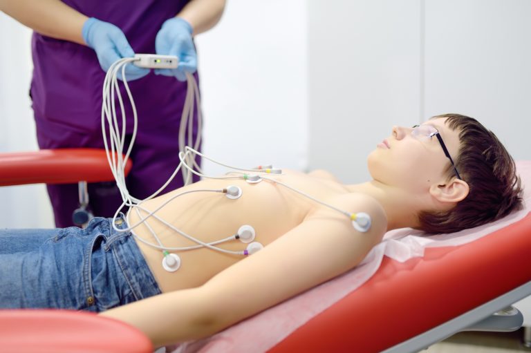 Child under ECG test with doctor