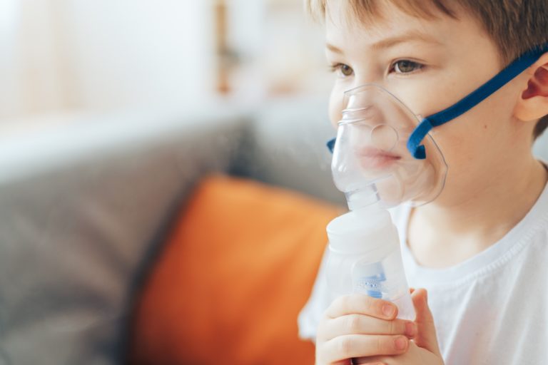 Little boy in mask from nebulizer close-up